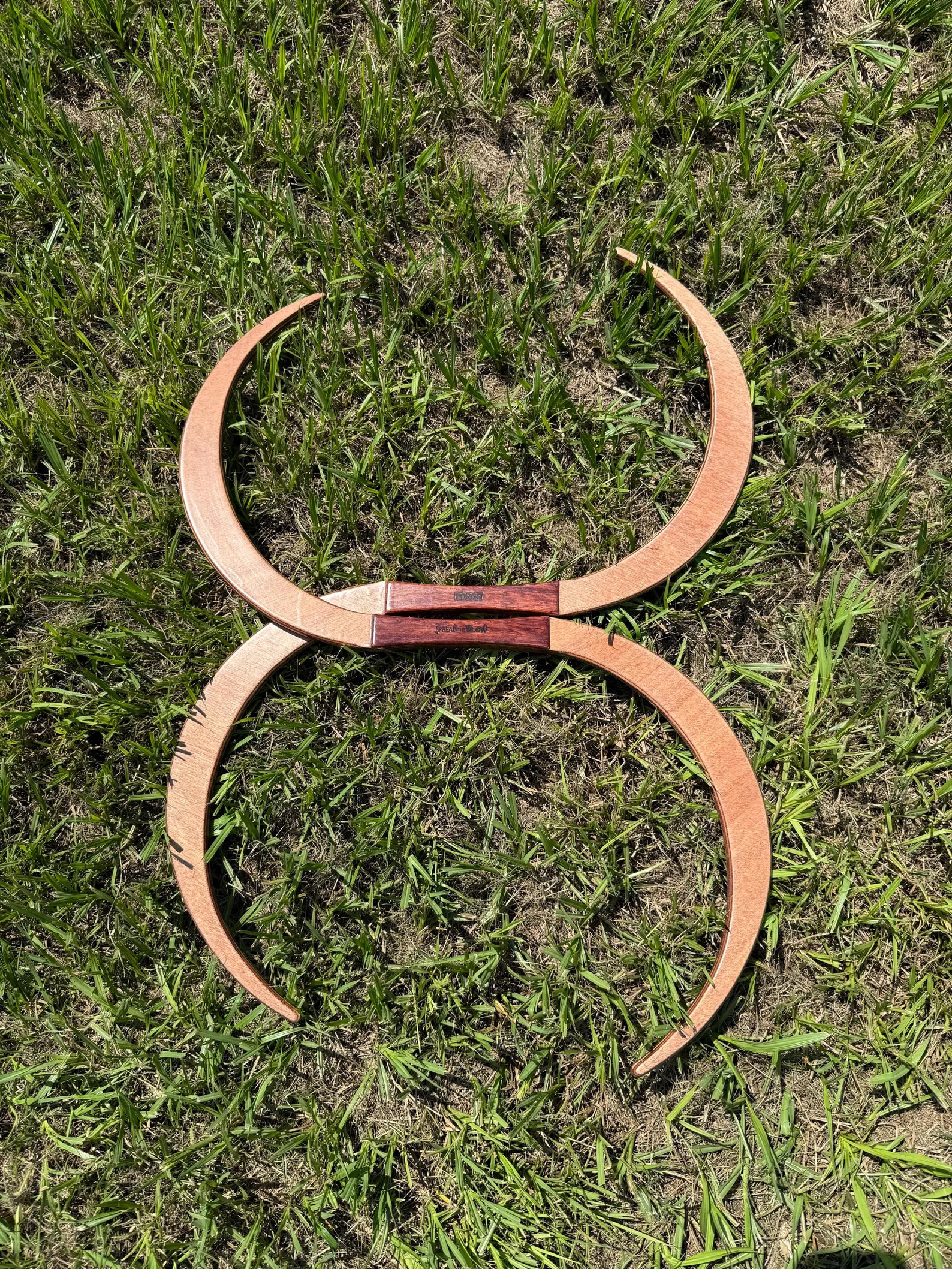 The 29.5in small TruGENG pair, staves joined at the grips into a figure-eight shape on the grass